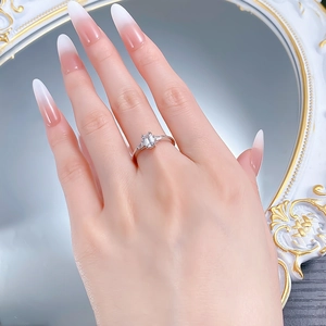 Close-up of emerald cut gemstone and trapeze side stones on a S925 silver ring band