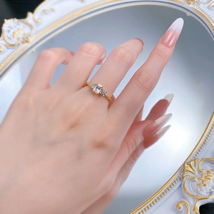 Detail of a vintage-style gold S925 silver ring with three square-cut clear gemstones