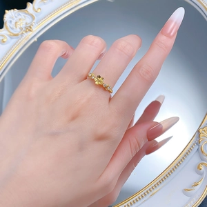 Detailed view of a gold-plated S925 silver flower ring with sparkling crystals on finger