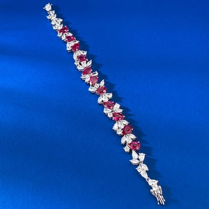 Close-up of S925 silver bracelet with pear-cut ruby red stones and cubic zirconia stones