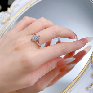 Marquise cut S925 sterling silver halo ring worn on finger with a reflective mirror effect