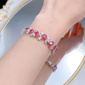 Macro shot of S925 silver bracelet with pear-cut pigeon blood red stones on model wrist