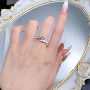 Close-up of S925 silver ring with square zircon and white enamel on finger