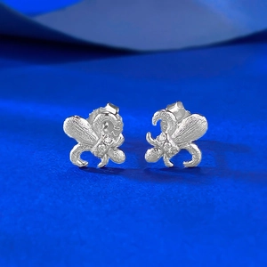 Macro shot of S925 sterling silver fleur-de-lis earrings with brushed texture and hallmark