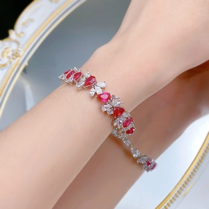 Macro detail of S925 silver bracelet with pigeon blood red rubies and white zircon stones