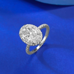 925 silver ring with large oval-cut gemstone in halo setting on deep blue background