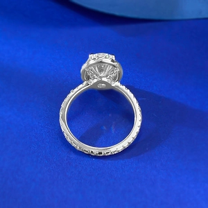 925 sterling silver halo ring with oval-cut stone and pavé band on blue background