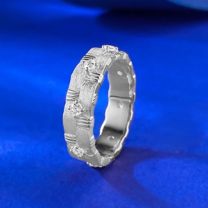 S925 sterling silver brushed ring with zircons and irregular texture on blue background
