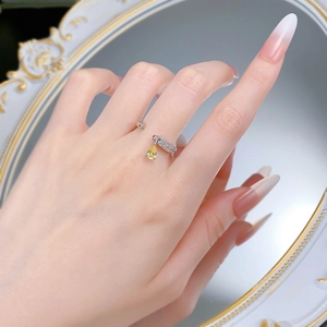 Macro view of pear-shaped yellow diamond ring with S925 silver band on hand