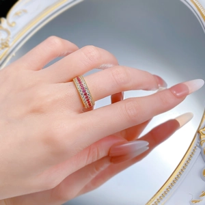 Detail of vintage style gold-tone ring featuring triple rows of micro-pave red and white gems