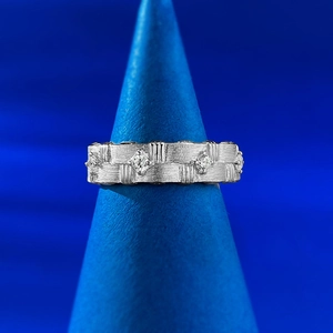 Detail of S925 sterling silver woven ring with brushed texture and zircon stones