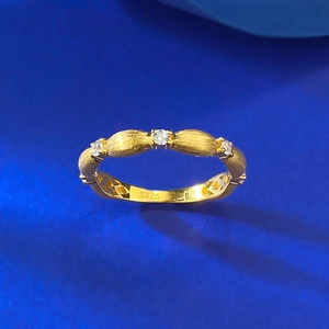 Macro detail of brushed S925 silver gold ring with three white zircon stones