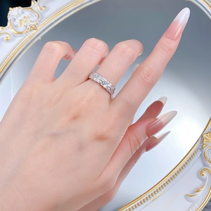 Detail of silver S925 woven ring with sparkling stones shown against a vintage mirror
