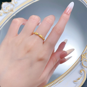 Close-up of gold-plated S925 silver ribbon ring with brushed texture and zircon stones