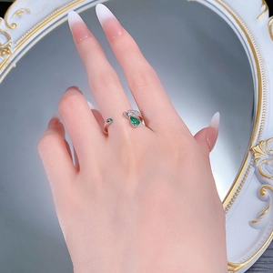 Detail of S925 silver adjustable ring featuring a pear-cut emerald and sparkling zircon