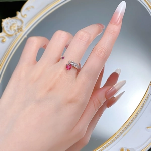 Close-up of S925 silver open ring with heart-shaped red gemstone and pavé diamonds