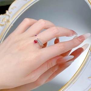 Detail of S925 silver adjustable ring featuring a red heart gemstone and micro-pave crystals