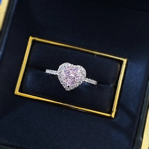 Exquisite S925 silver heart-shaped pink gem ring with halo diamonds on blue velvet
