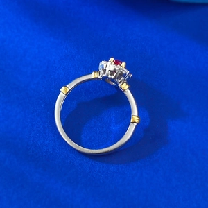 S925 silver retro flower ring with oval red gemstone and crystal halo on blue fabric