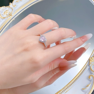 Elegant S925 silver ring featuring a pink heart-shaped stone on a woman's hand
