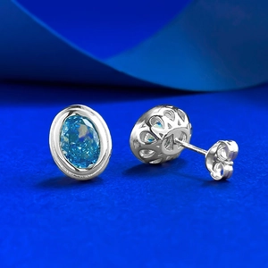Detail of S925 silver studs with blue ice-cut crystal and intricate hollow back pattern