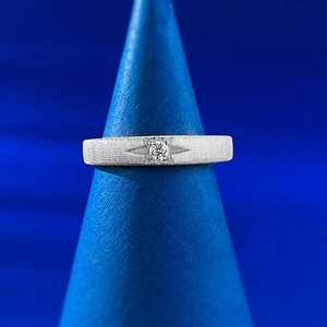 Macro shot of S925 sterling silver ring with brushed finish and starburst setting