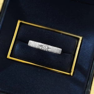 Macro shot of S925 sterling silver ring with brushed texture and star-set zircon detail