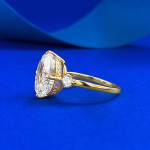 Macro side view of gold plated silver ring with oval cut gemstone and side stones