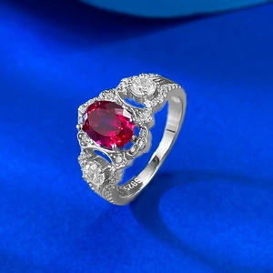 Elegant S925 sterling silver ring with oval red gemstone and pavé white diamonds on blue silk