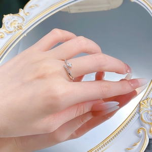 Macro shot of silver snake-shaped ring with pear-cut zircon and sparkling accents