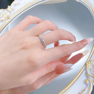 Detail of S925 sterling silver ring with brushed finish and single diamond star engraving