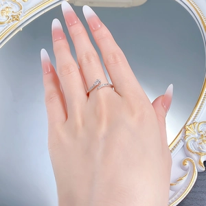 Macro detail of S925 silver ring featuring intricate crossover design with pave zircons