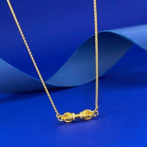 Macro shot of S925 silver gold-plated Vajra pendant necklace with sparkling white zircons