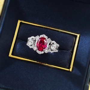 Macro view of vintage S925 silver ring featuring a large oval red ruby and pavé accents