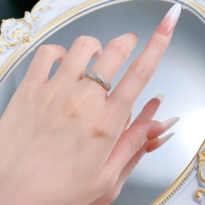 Detail of twisted silver ring with micro-pave zirconia set against a vintage mirror