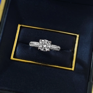 S925 sterling silver four-prong diamond ring featuring a pavé band in a jewelry box