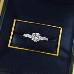 Classic S925 silver four-prong 6.5mm round diamond ring in a navy blue velvet jewelry box