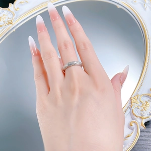 Detailed view of silver woven twist ring with small cubic zirconia worn on hand