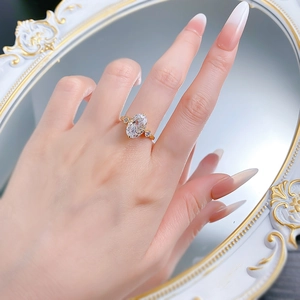 Close-up of golden S925 silver ring with oval ice-flower cut stone on hand