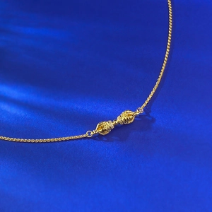 Macro detail of gold S925 silver Vajra pendant necklace with sparkling diamonds