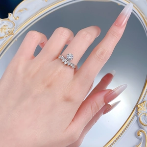Close-up of S925 sterling silver crown ring set with round cut and V-shaped stones