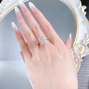 Detailed view of rectangle cut ice flower ring with gold band on model's hand