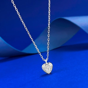 Macro detail of S925 silver heart pendant necklace with shimmering cubic zirconia stone