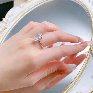 Close-up of a 9x13mm oval cut sparkling crystal ring with four-prong silver setting