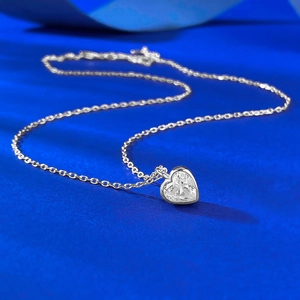 Macro view of heart-shaped clear zircon pendant on silver S925 cable chain necklace