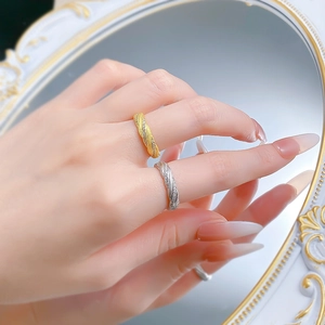 Detailed view of woven S925 silver rings in gold and silver finish with zircon accents