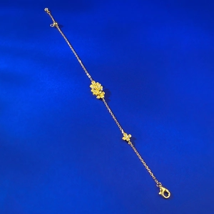 Elegant gold S925 silver flower bracelet with sparkling crystals on blue silk background