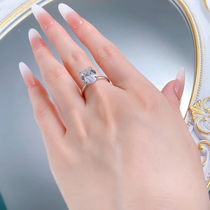 Close-up of a 9x13mm oval cut sparkling cubic zirconia ring on a model's hand