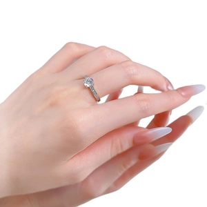 Classic S925 sterling silver four-prong ring with a 6.5mm round cut stone on a model's hand