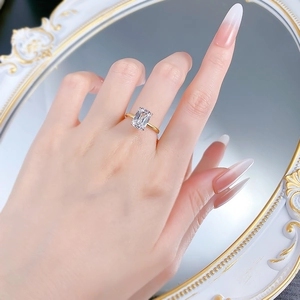 Close-up of a gold S925 silver ring featuring a large rectangular radiant cut gemstone